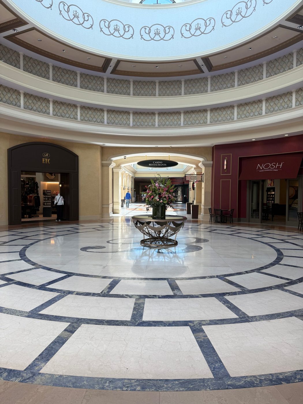 Domed rotunda with a marble floor and a floral centerpiece at Belterra Casino Resort
